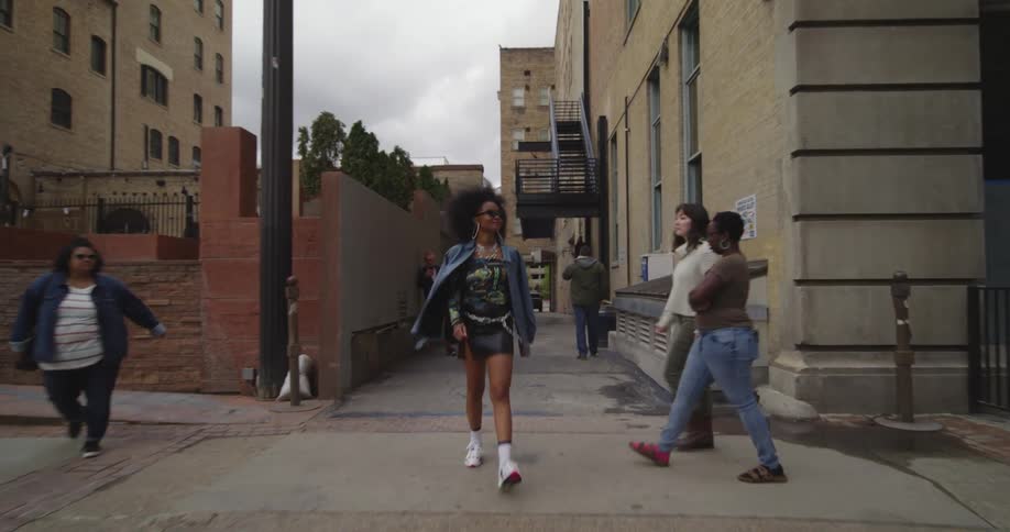 There are people that are walking down the street in the downtown area