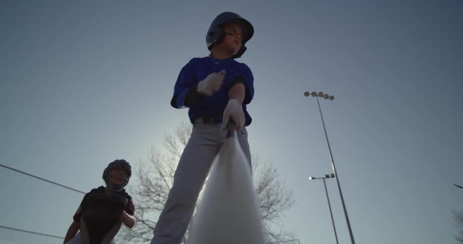 A child with a baseball bat on the field