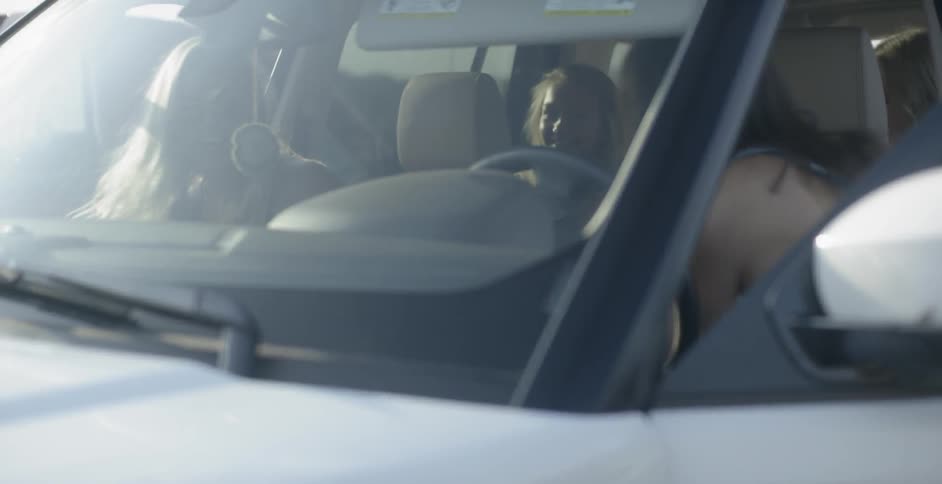 A group of friends in a car in the day