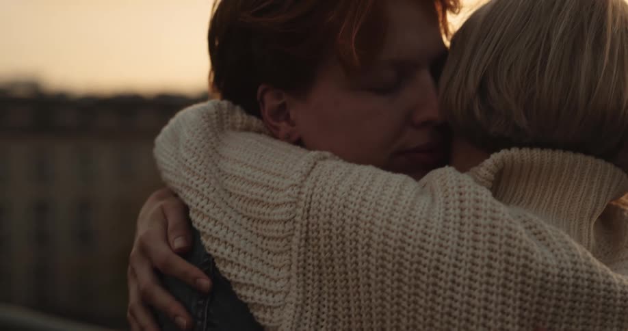 A couple hug while dancing on their rooftop