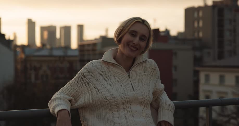 A woman smiles on the roof top