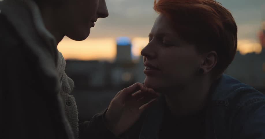 A woman kisses her partner on the forehead