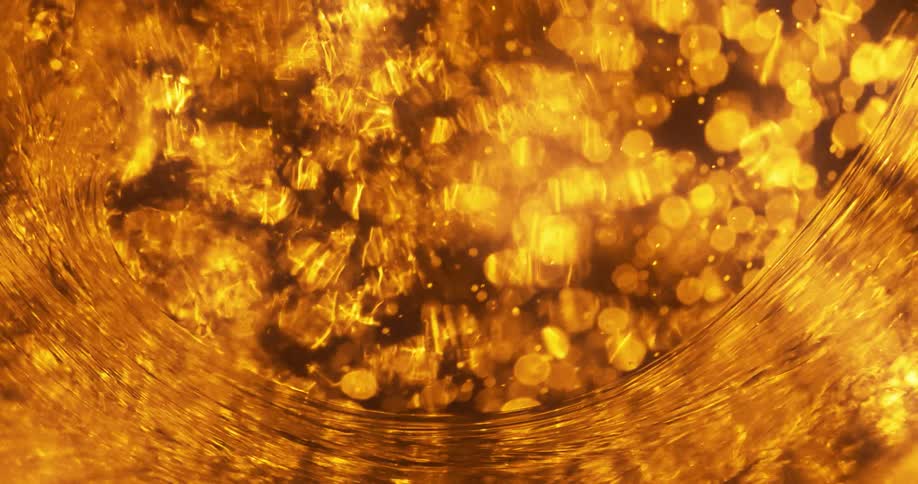 Golden orbs floating beneath a rippling surface