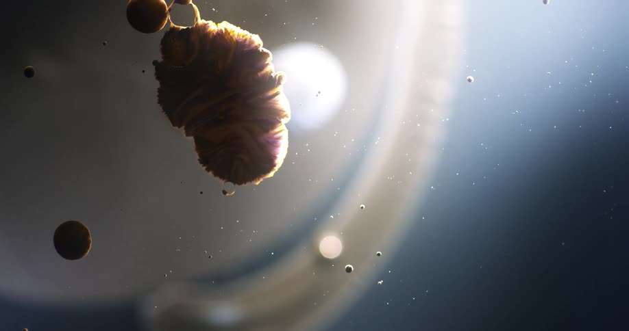 Glob releases bubble and contracts as it floats in translucent liquid