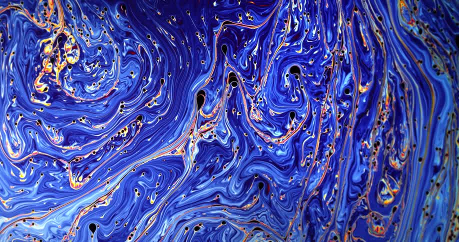 Swirling blue liquid ink flowing in strains of psychedelic patterns