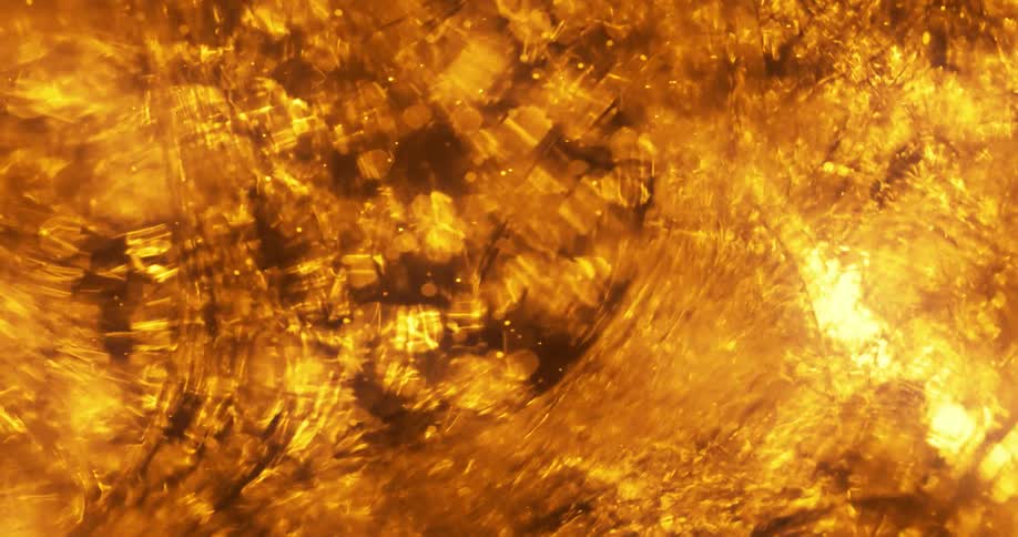 Textures orbs and liquid swirls into gold light and shadows