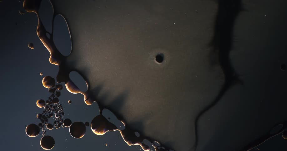 Flowing dark liquid and droplets