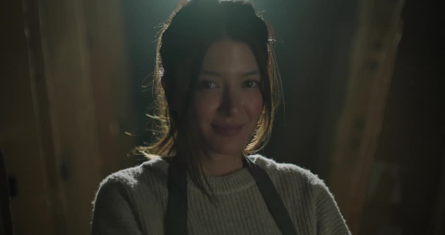 Female boss smiling at camera in her factory
