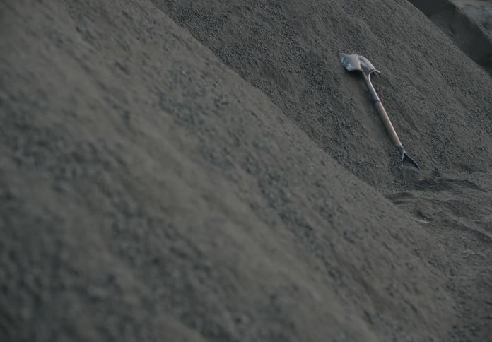 A shovel lies in a pile of dirt