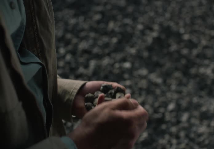 A man drops stones in the quarry