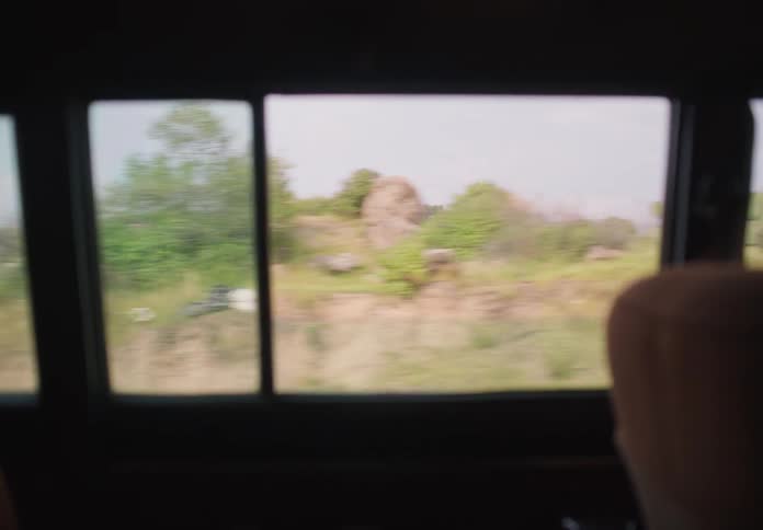 Man driving a car through the countryside at daytime