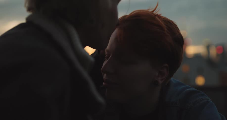 A woman kisses another on the forehead