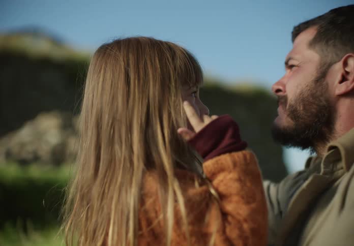 A little girl and her father playing outside