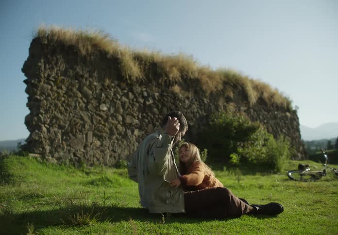 Father and daughter are playing outside in the grass