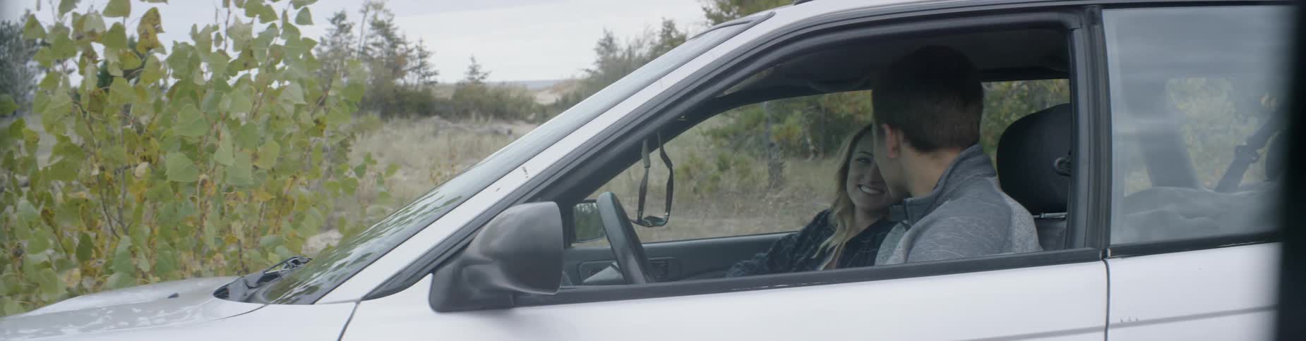 Man and woman in a vehicle laughing