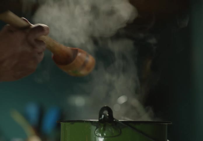 A man is preparing food in his kitchen