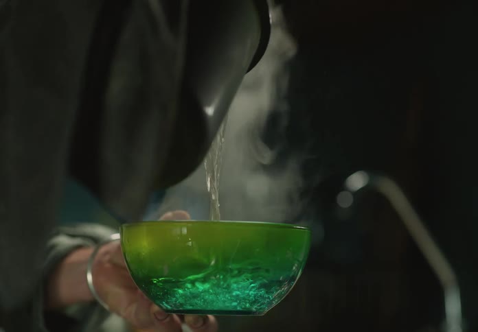 A person pouring water into a bowl