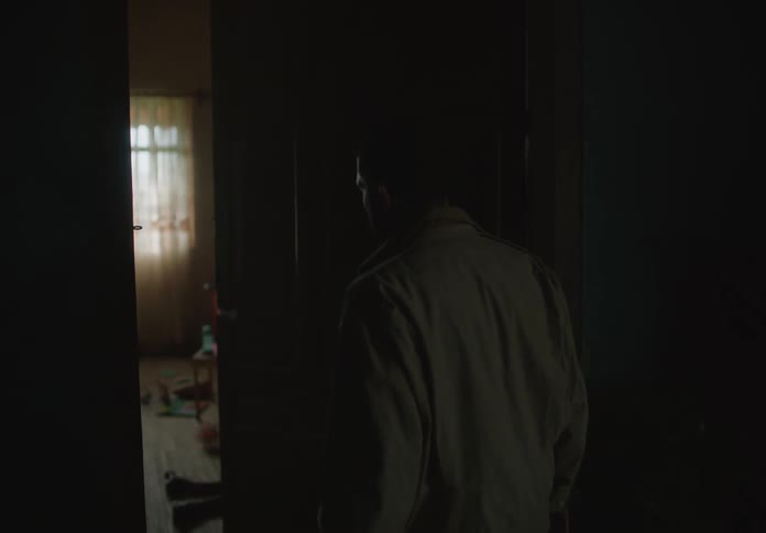 A man opens the door to a child laying on the floor