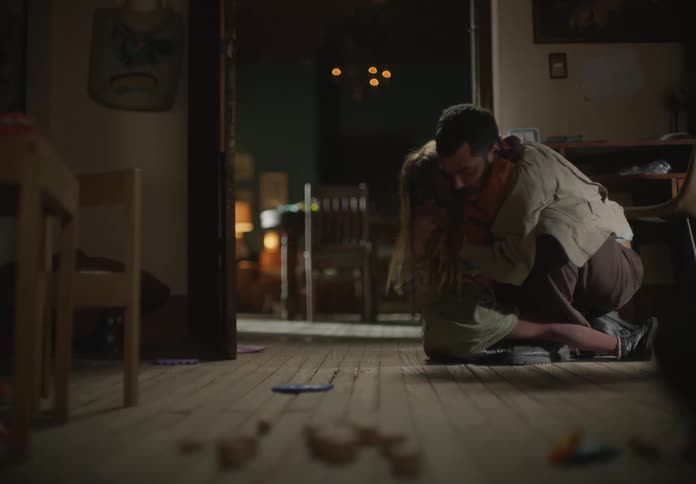 Father and daughter are playing around in a room together