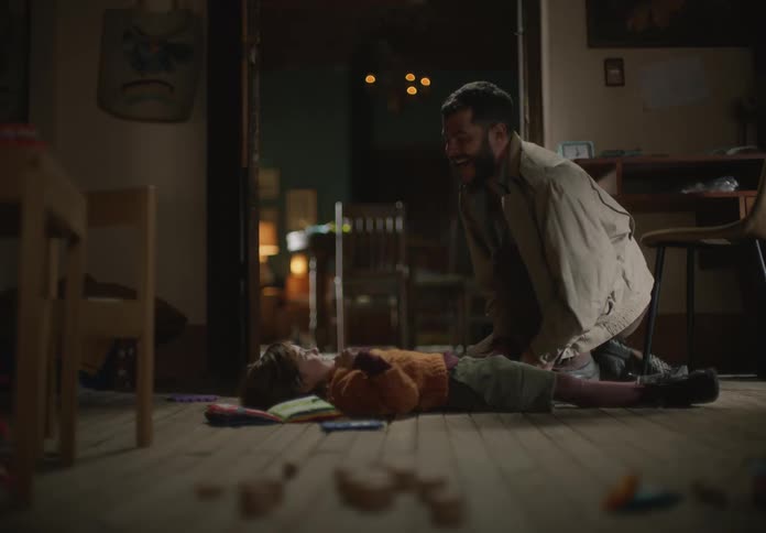 Father and daughter playing on the floor of the living room