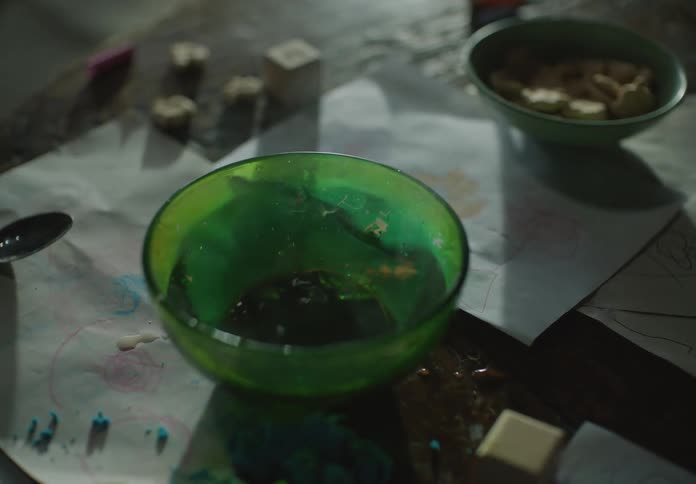 Green glass bowl filled with hot water over a table shakes with an earthquake