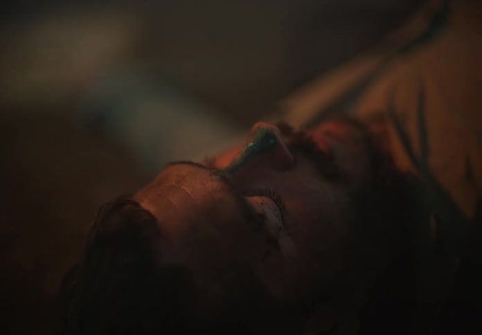Unconscious man laying on the floor of a room