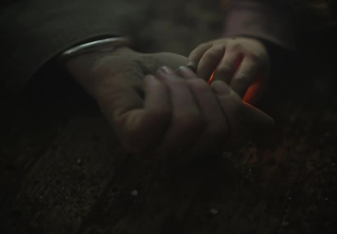 Hand of a baby delivers a warm yellow orb to a man