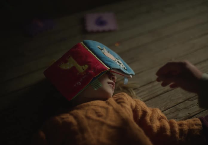 A child jumps from playing dead on the ground