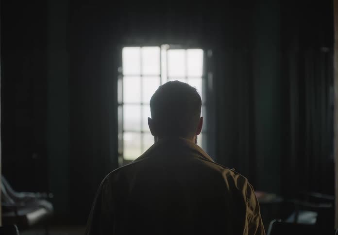 A man stands and begins to walk then stops and looks scared as he looks to his side