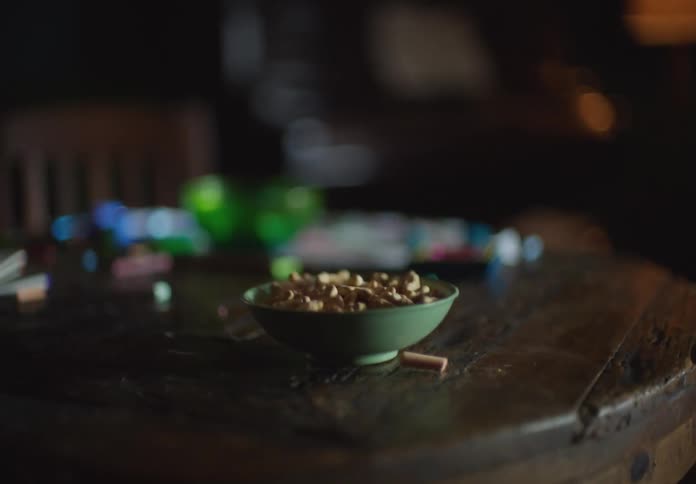 Close up of pieces of chalk falling off the surface of a shaking table
