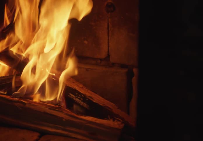 Close up of the flames of a fire burning on the fireplace at home