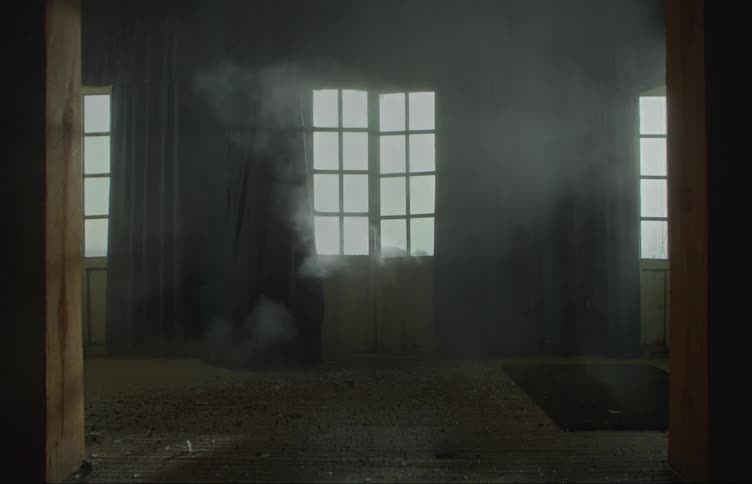 Explosion breaks the window of a house filling the living room with smoke