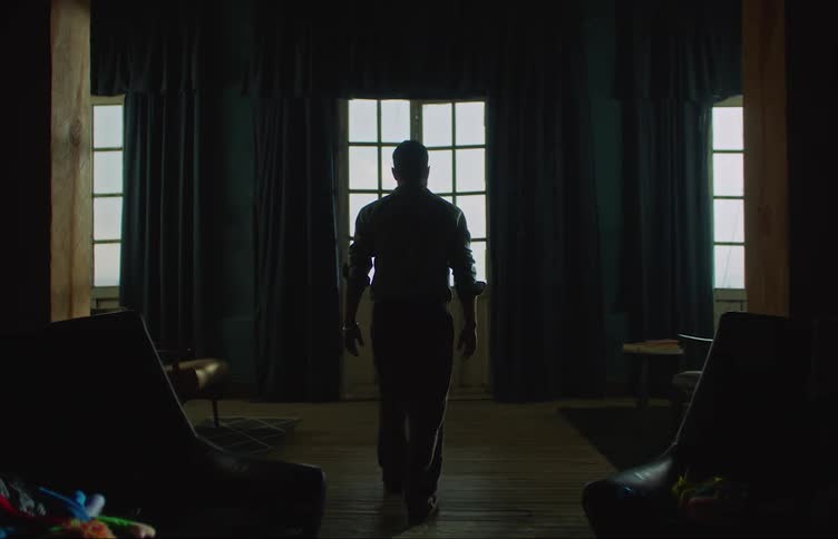 Man walking on the living room suddenly jumps and falls on the floor