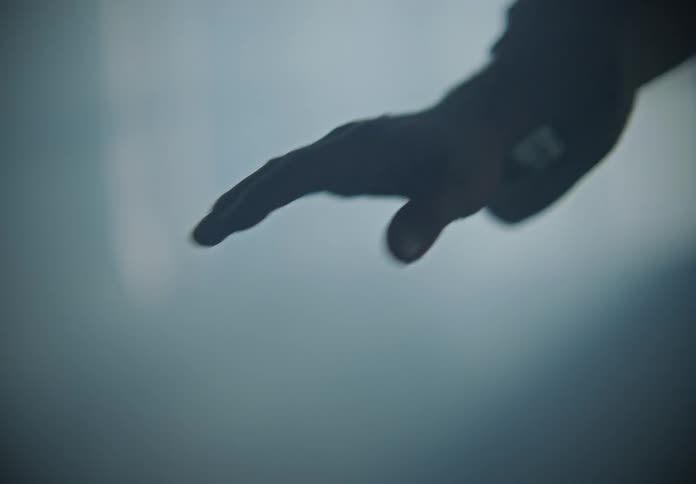 A male coughing and walkin in a smoke filled room