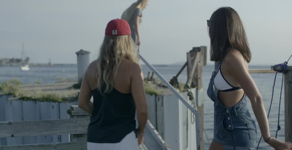 Four women are near the water playing around