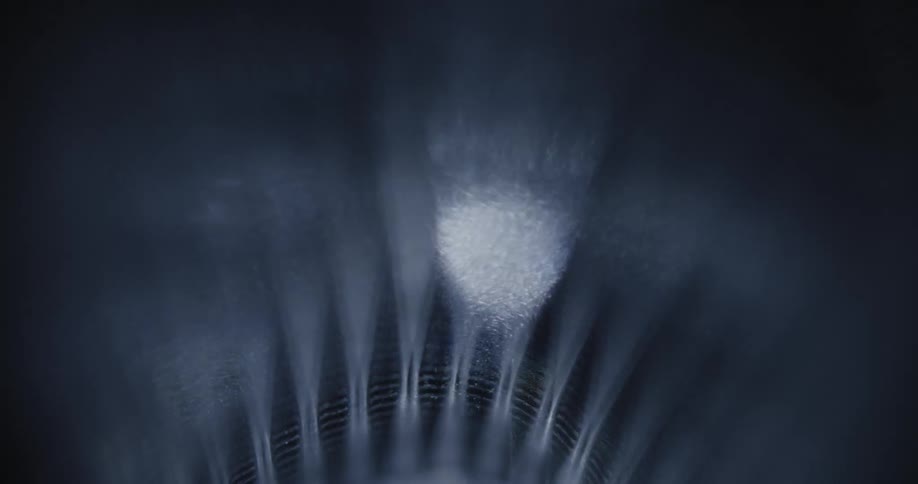 White light flows across surface of object illuminating ribbed notched pattern
