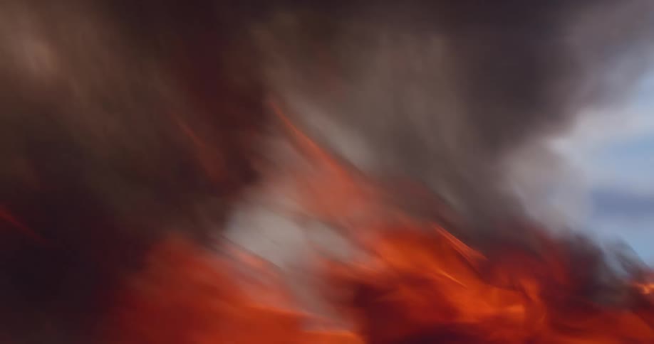 A raging blaze burns wildly as black smoke rises from the flames