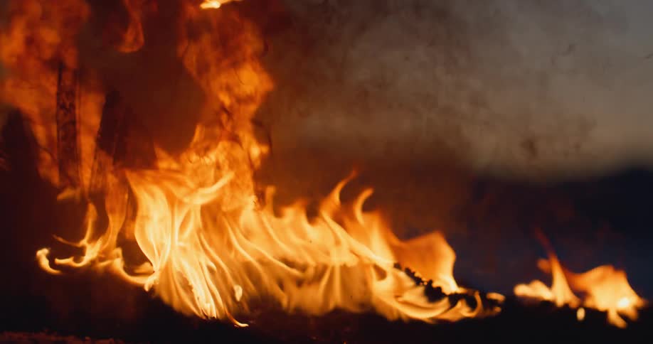 Close up of the remains of a burning tire in the desert at evening