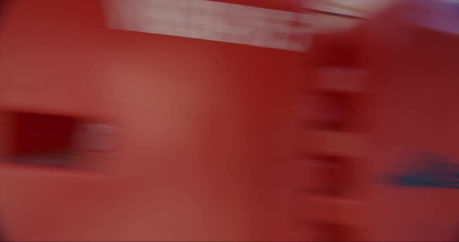 Red and white train cars move from left to right
