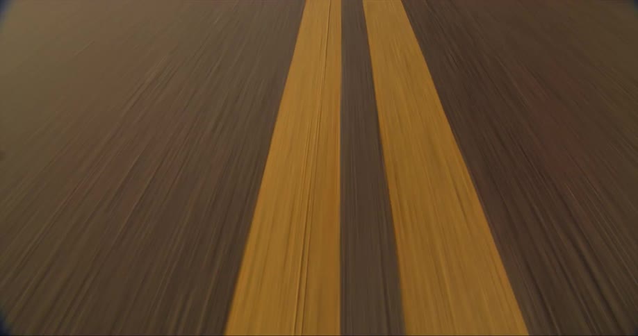 Yellow lane markings on a road during the day