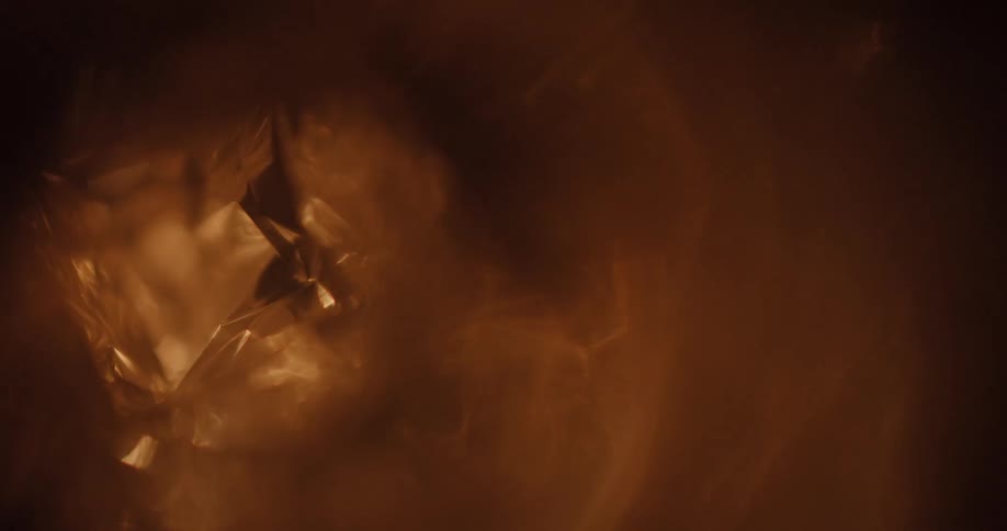 Close up of the reflection of flames on a cristaline surface
