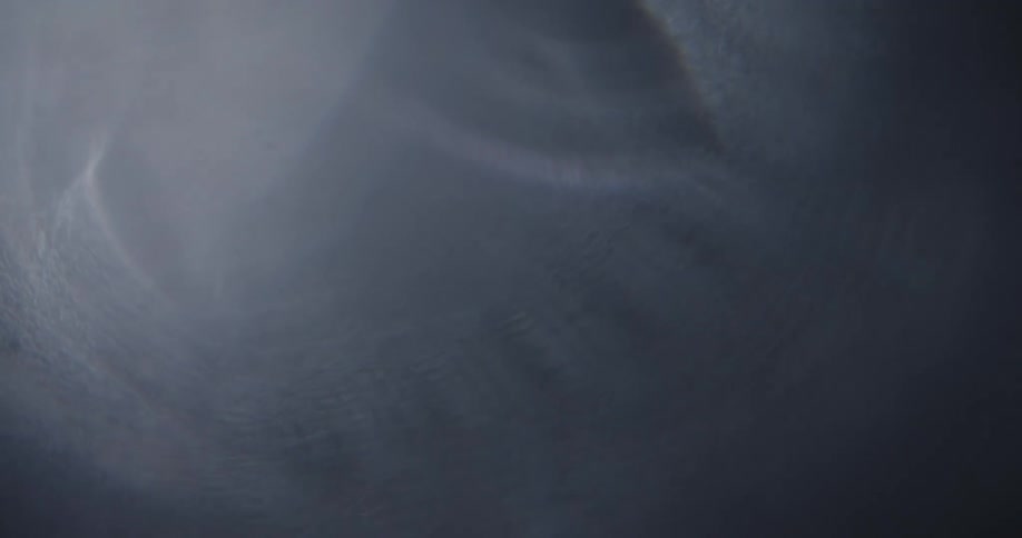 A light comes on and reveals the texture on a black ridged object