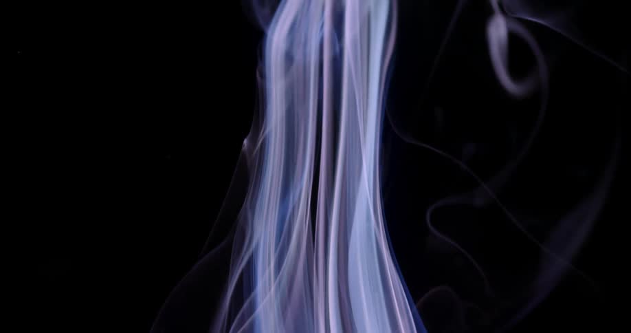 Pale multicolored gaseous filmy layers rise contrasting with black background