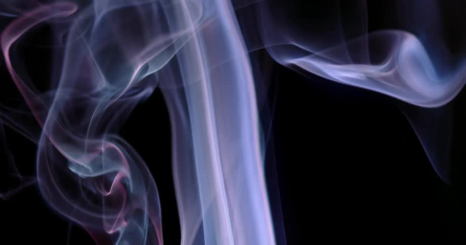 Wisps of mystical smoke bend and move as they rise in the darkness