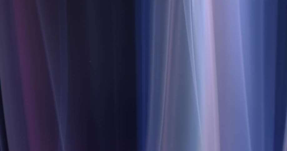 Glowing lines in shades of blue and white and pink merging and swaying against black