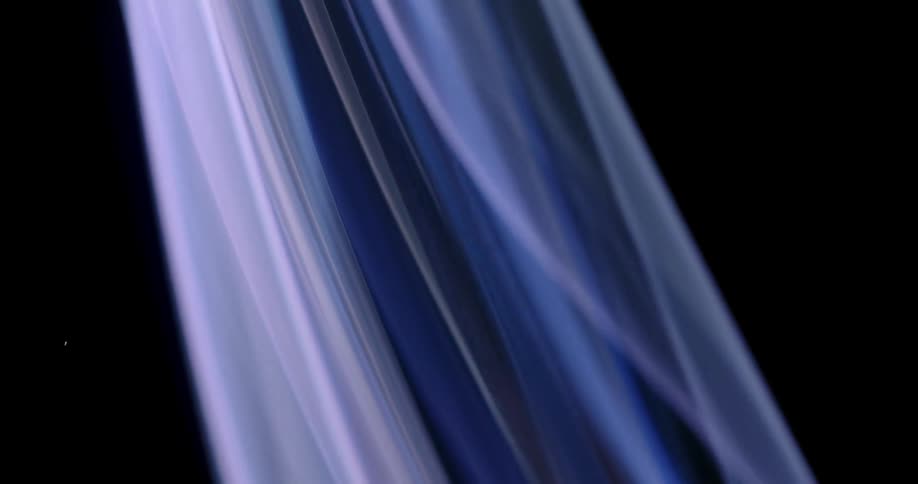 Wisps of mystical lavender smoke bend and sway as they rise in the darkness