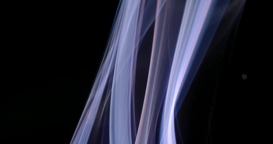 Wisps of mystical lavender smoke bend and sway as they rise in the darkness