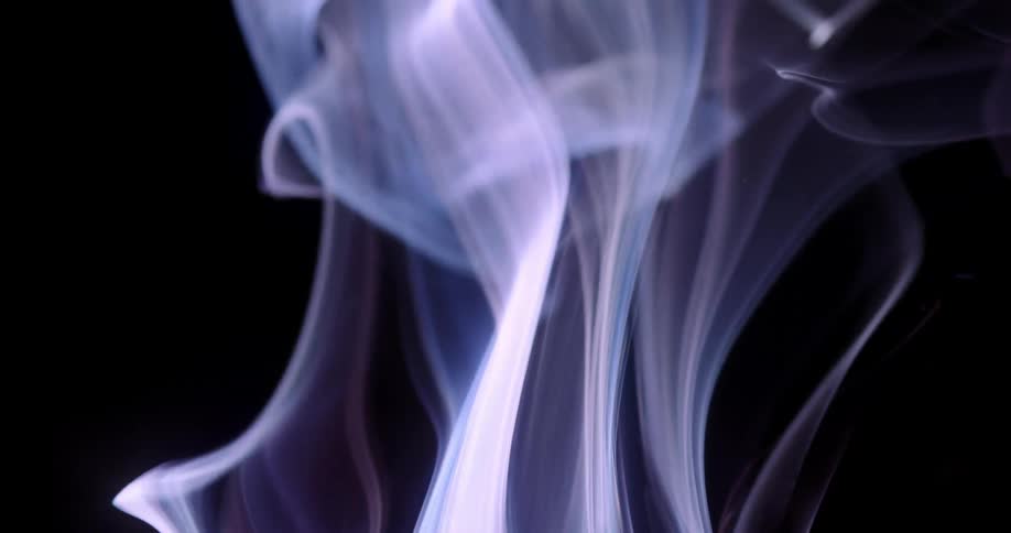 Wisps of mystical lavender smoke bend and sway as they rise in the darkness