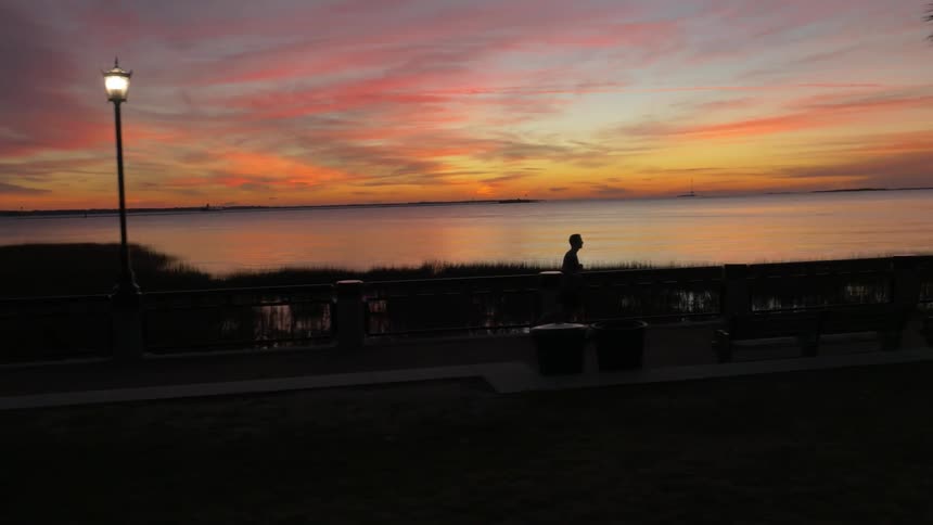 A man is jogging at dawn