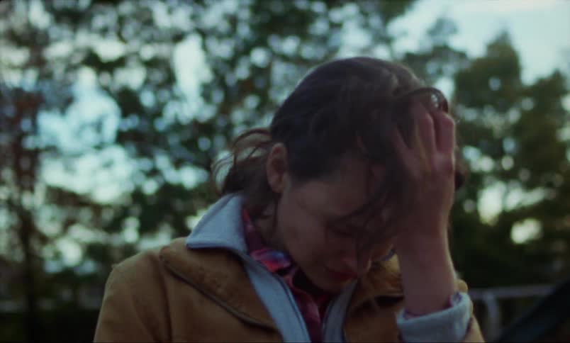A young woman is outside and she looks very upset